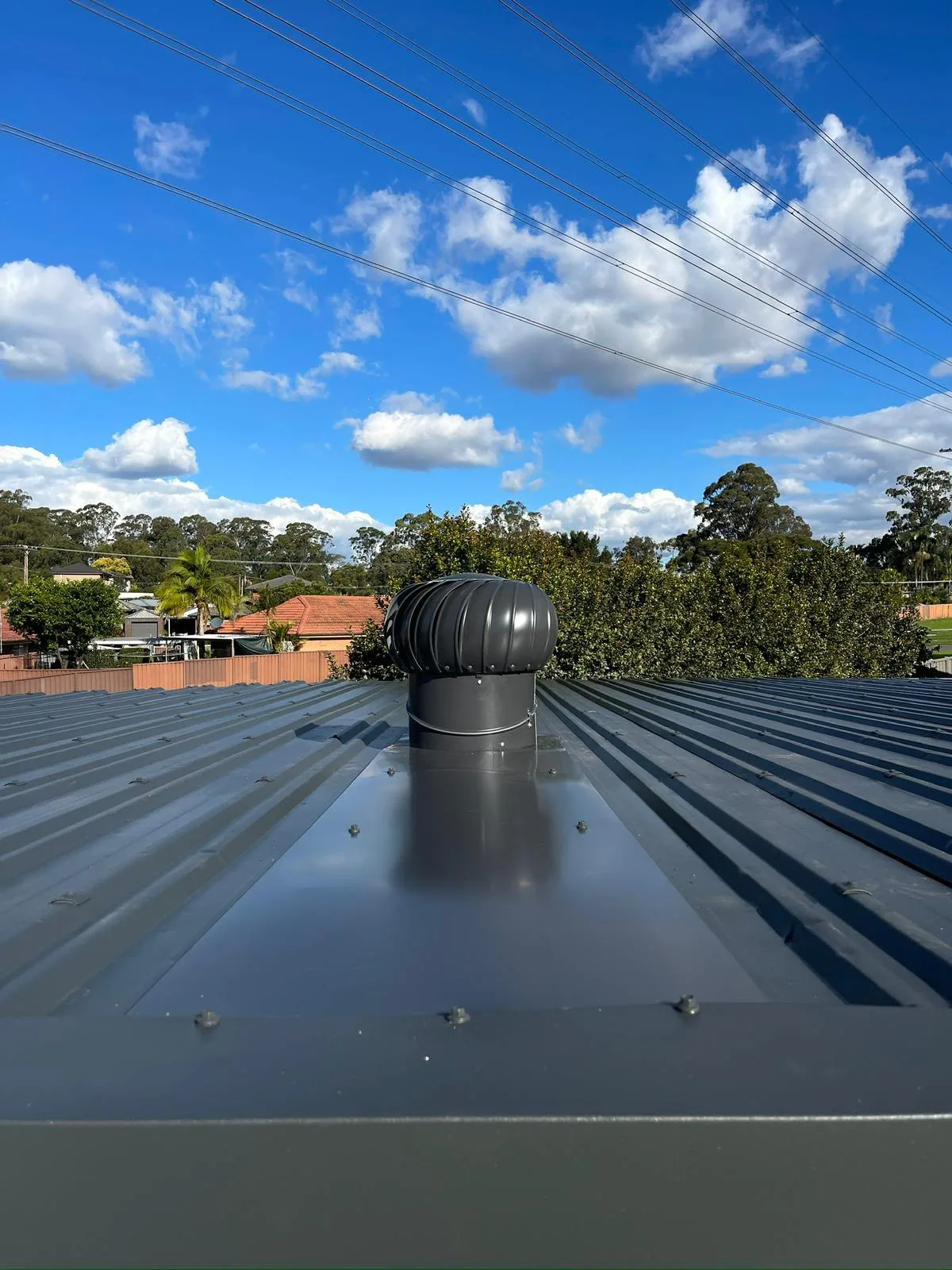 Roof turbine ventilator installed on metal roofing